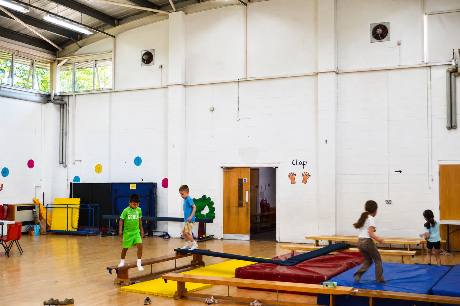 The main hall at camp, set up with balance beams, benches and crash mats